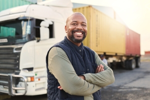 Fleet compliance manager standing in front of a truck